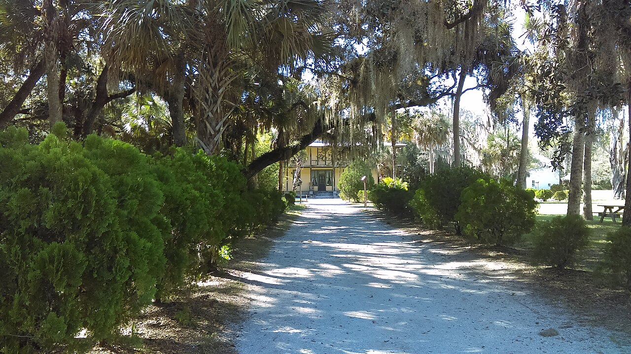 Tree-lined path to Planetary Court at Koreshan State Historic Site in Estero